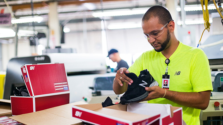 A worker packs boxes at the New Balance shoe factory in Lawrence, Massachusetts.