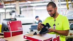 A worker packs boxes at the New Balance shoe factory in Lawrence, Massachusetts. A worker packs boxes at the New Balance shoe factory in Lawrence, Massachusetts.
