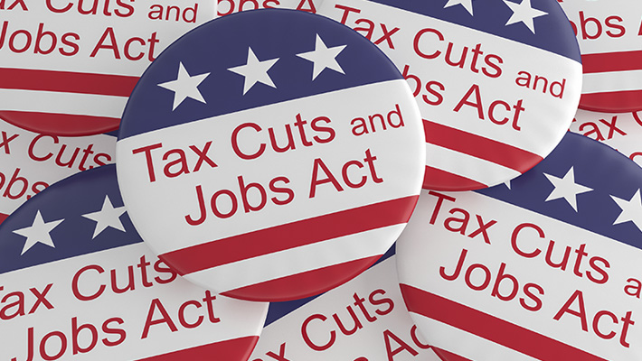 A pile of buttons trumpeting the Tax Cuts and Jobs Act.