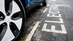 An electric Kia parked on the street. An electric Kia parked on the street.