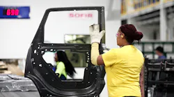 A woman works on a door at the Fiat Chrysler plant in Warren, Michigan.
