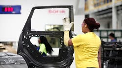 A woman works on a door at the Fiat Chrysler plant in Warren, Michigan. A woman works on a door at the Fiat Chrysler plant in Warren, Michigan.