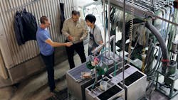 3 men examining something 3 men examining something