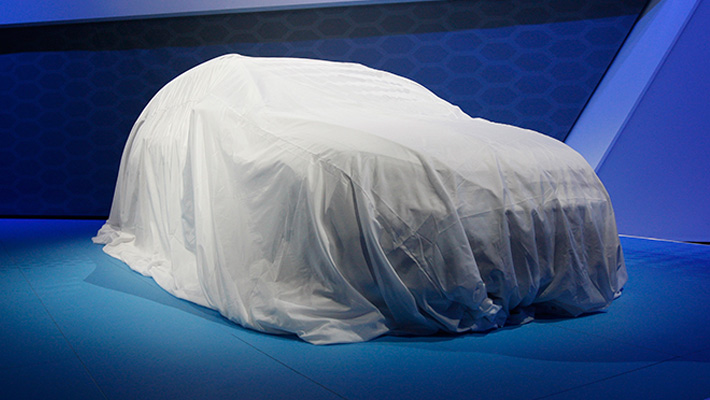 A car under a sheet, waiting to be unveiled.
