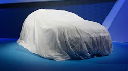 A car under a sheet, waiting to be unveiled.