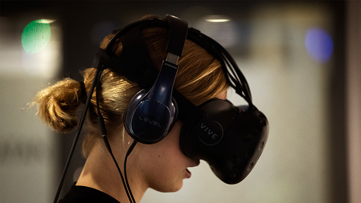 A woman wears an HTV Vive VR headset.