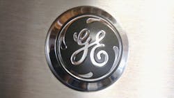 The GE logo appears on the front of a home appliance. The GE logo appears on the front of a home appliance.