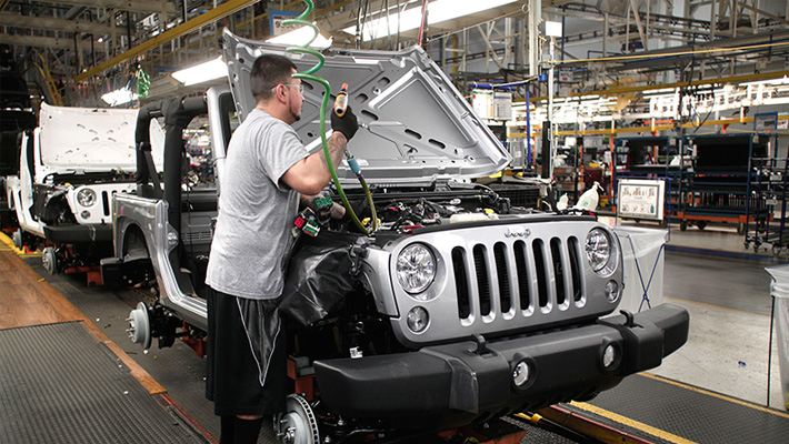 A worker assembles a Jeep Wrangler at the Fiat Chrysler Automotive plant in Toledo, Ohio.