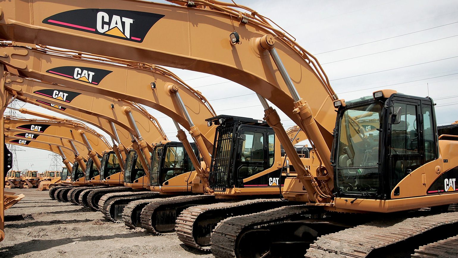 A row of Caterpillar earth-moving equipment.
