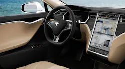 The steering wheel and dashboard user experience inside a Tesla Model S.