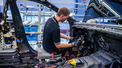 guy working on Mercedes at Germany factory