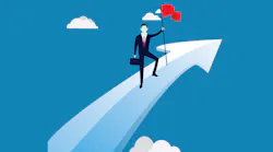 Businessman plants flag on upward arrow