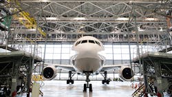 A Boeing 777 airliner at rest in a hangar in Tokyo. A Boeing 777 airliner at rest in a hangar in Tokyo.