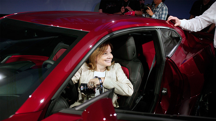 GM CEO Mary Barra sits inside a new Chevy Camaro.