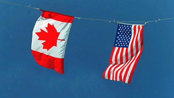 canada and US flag hanging from a line