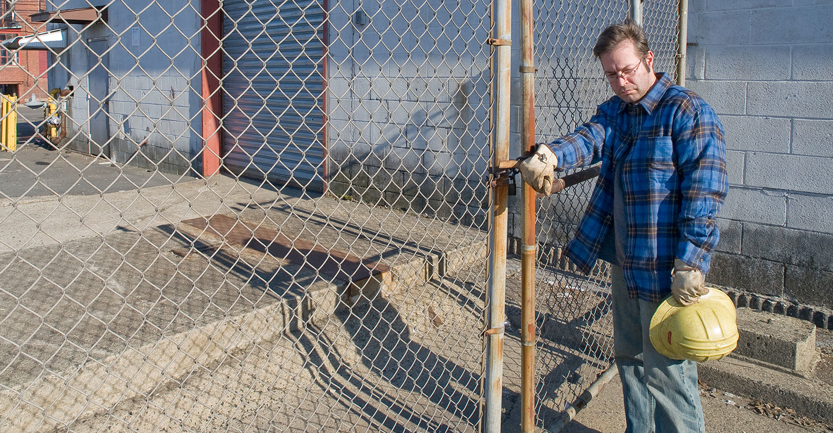 worker-left-behind-fence