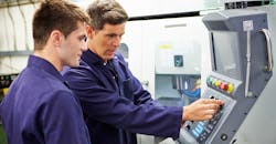 student at automated milling machine student at automated milling machine