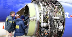 National Transportation Safety Board investigators examine damage to the CFM International 56-7B turbofan engine belonging Southwest Airlines Flight 1380.