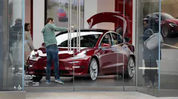Red Tesla Model 3 in showroom