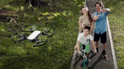 A promotional photo of a family taking a selfie with the DJI Spark drone