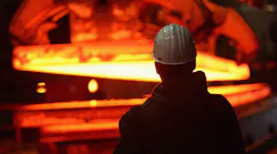 back of guy's head looking at hot steel