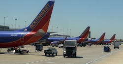 Row of Southwest Airline jets at an airport Row of Southwest Airline jets at an airport