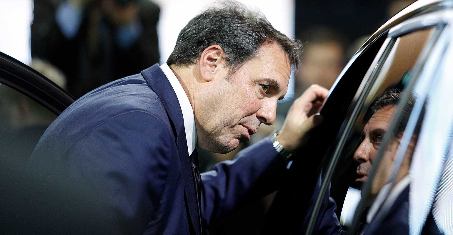 General Motors' Mark Reuss looks in car window