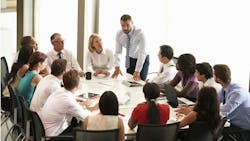 team of people around a table team of people around a table