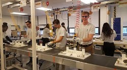 Students learning on a mock assembly line.