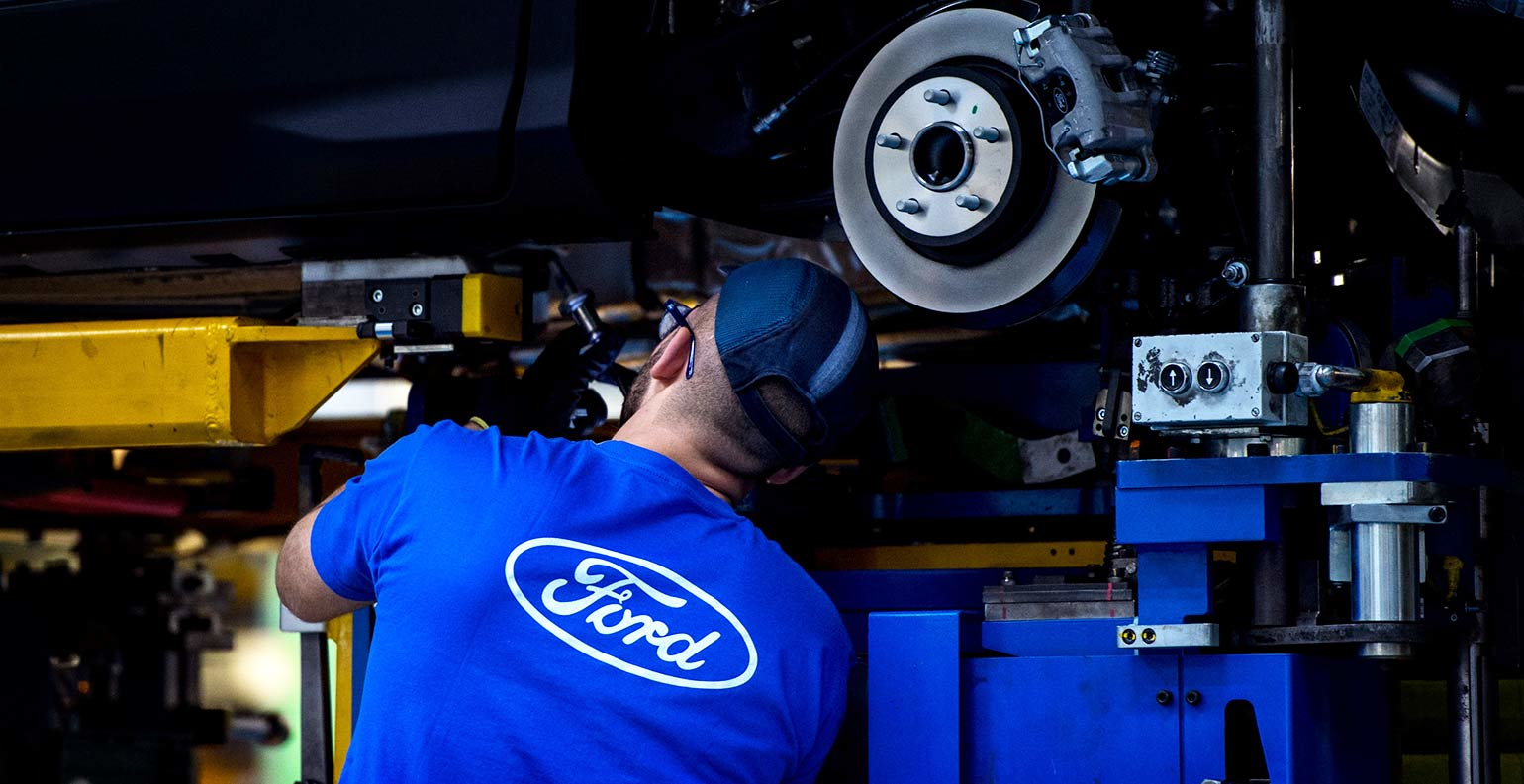 Employee works on Ford Mondeo at factory in Valencia, Spain.