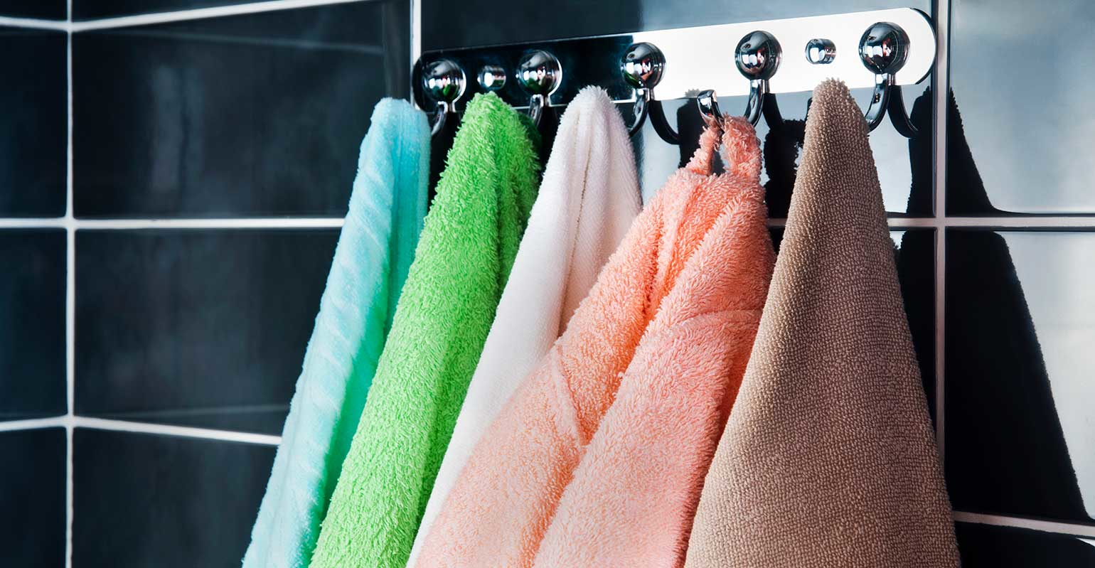 brightly colored towels hanging from hooks