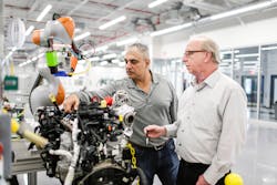 Ford technical specialists Harry Kekedjian and Frank Maslar analyze a cobot.