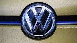 The Volkswagen logo on a car grille The Volkswagen logo on a car grille