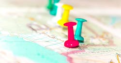 close up of map with pins in it close up of map with pins in it