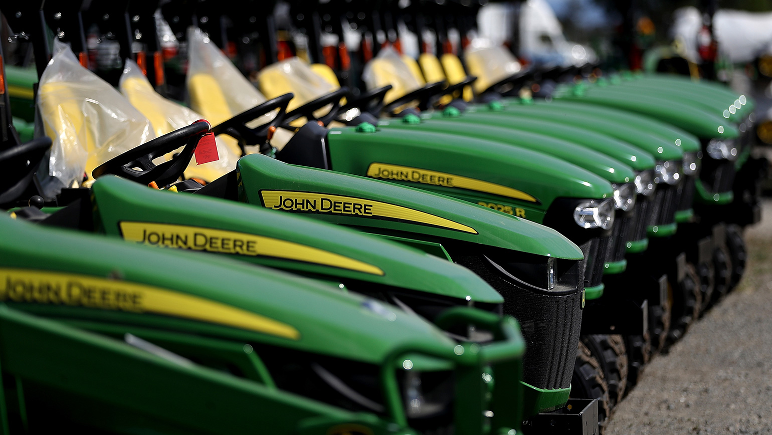 A row of John Deere tractors.