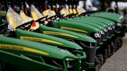 A row of John Deere tractors. A row of John Deere tractors.