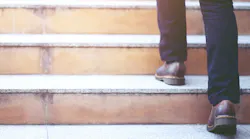 man walking up stairs