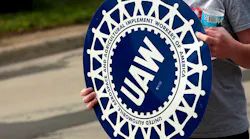 UAW-striker-holds-logo-sign-JEFF-KOWALSKY-AFP-Getty-Images.jpg
