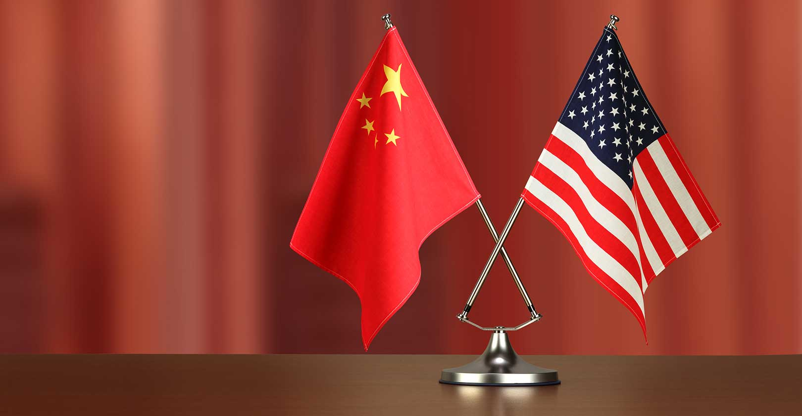 chinese-american-crossed-flag-on-desk-negotiation-studiocasper-istock-getty2.jpg