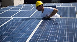 Industryweek 36205 Solar Panel Installation Worker Yellow Hardhat Robert Nickelsberg Getty