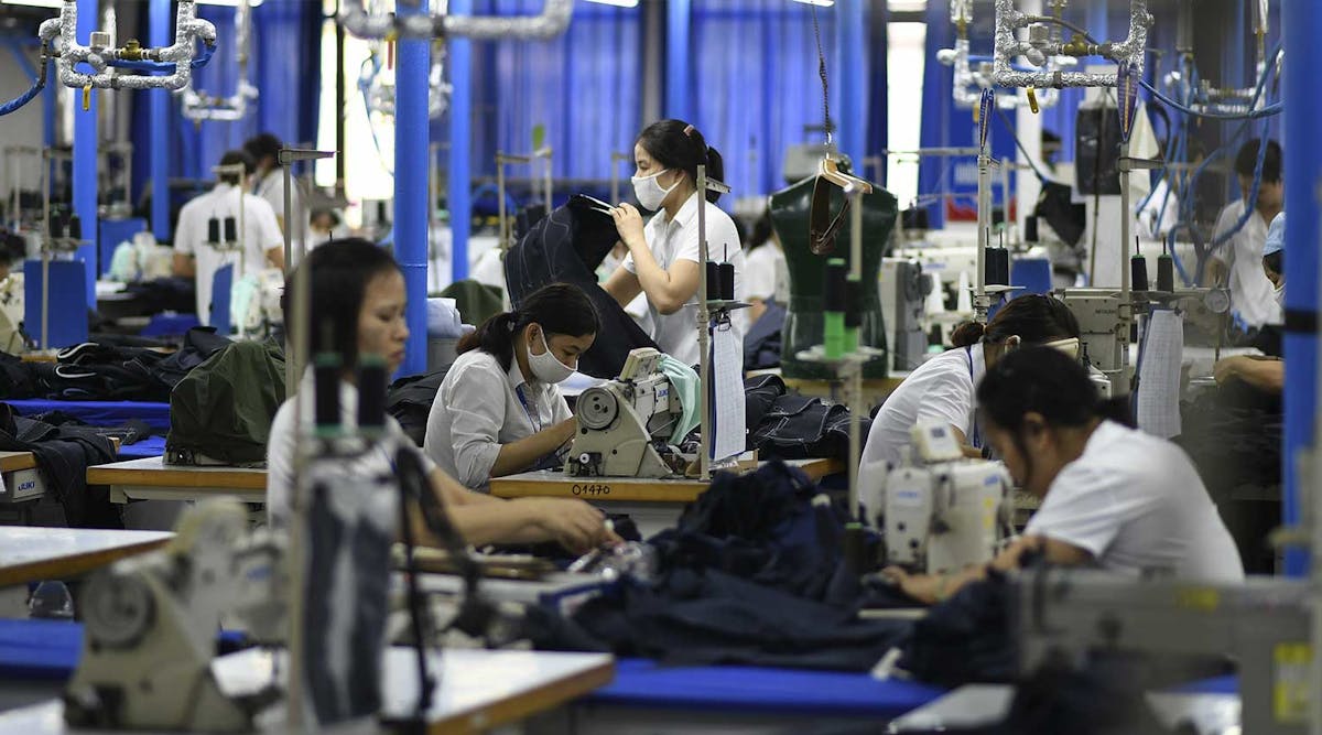 Garment workers making men&apos;s suits in a factory in Hanoi, Vietnam.