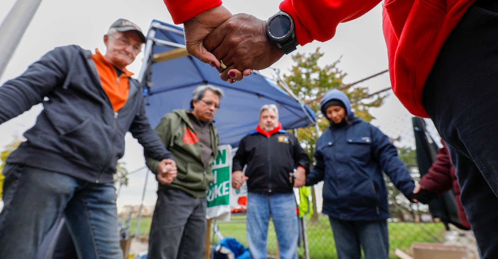 UAW-GM-workers-holding-hands-Bill-Pugliano-Getty.jpg