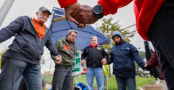 UAW-GM-workers-holding-hands-Bill-Pugliano-Getty.jpg UAW-GM-workers-holding-hands-Bill-Pugliano-Getty.jpg