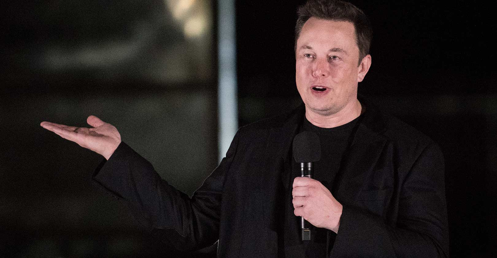 elon-musk-black-jacket-mic-speaking-Loren-Elliott-Getty.jpg