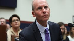 Dennis Muilenburg testifying on Capitol Hill amid a roomful of plane crash survivors in October 2019.