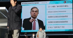 Pedestrians walk past a big screen showing images of former Nissan Motor Co. Chairman Carlos Ghosn in a news program on January 09, 2020, in Tokyo. Pedestrians walk past a big screen showing images of former Nissan Motor Co. Chairman Carlos Ghosn in a news program on January 09, 2020, in Tokyo.