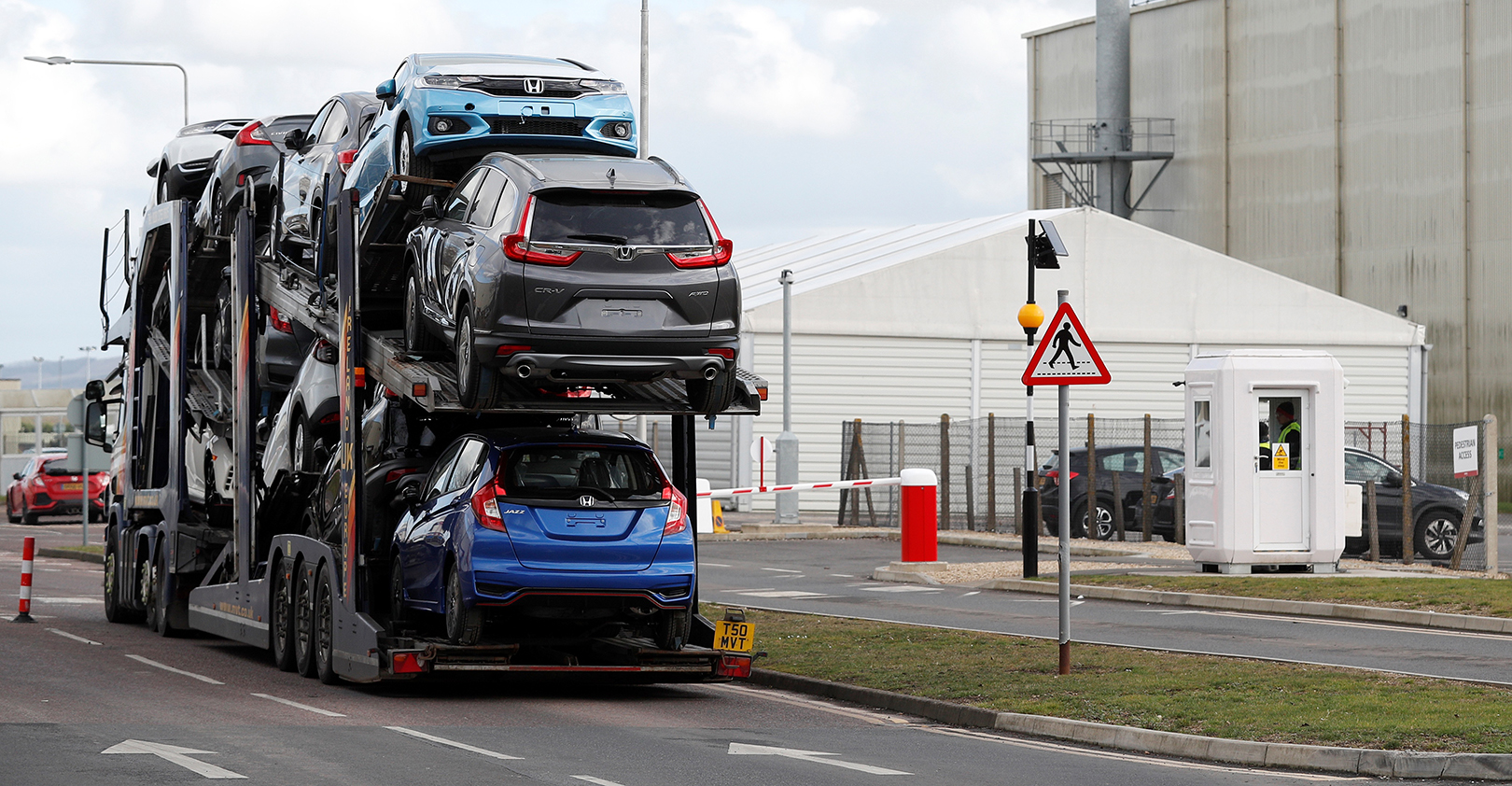 A car transporter loaded with Honda vehicles is driven in to the Honda manufacturing plant in Swindon, southwest England on February 19, 2019.