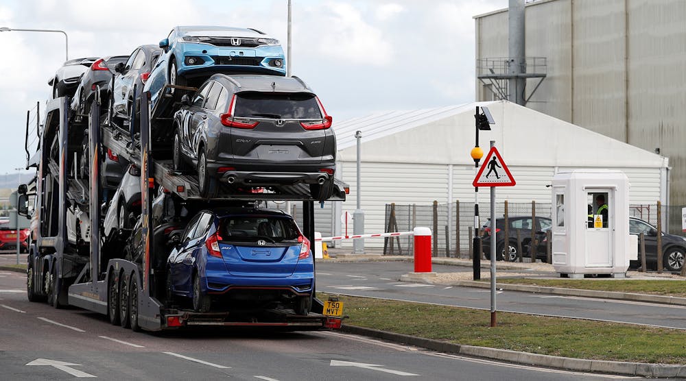 A car transporter loaded with Honda vehicles is driven in to the Honda manufacturing plant in Swindon, southwest England on February 19, 2019.