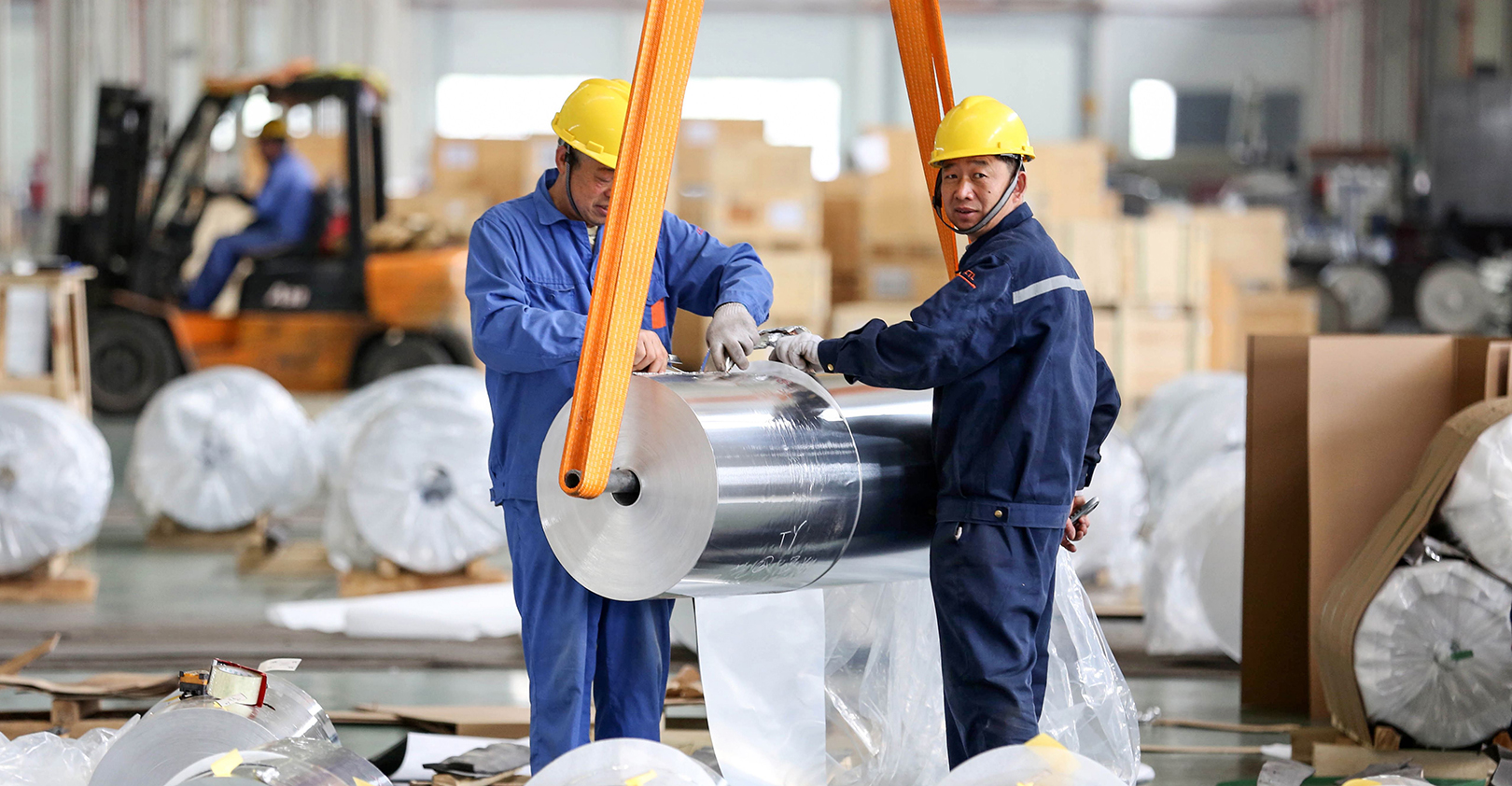 Workers at a factory in Huaibei, China, package sheet aluminum.