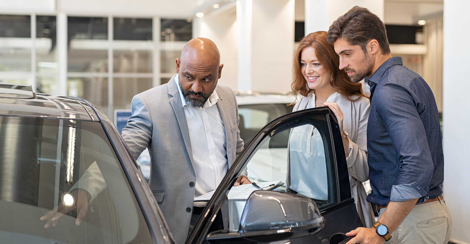 Auto Salesman Selling Car To Young People Istock Getty 5e1ce1aef0772
